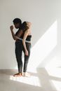 Woman Standing Back to Back while Being Tied by a Metal Chain