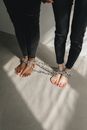 Two People's Feet Bound With Chains