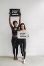 Woman in Black Sports Bra and Blue Denim Jeans Holding Black Box
