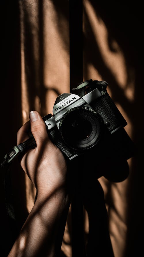 Close-Up Shot of Person Holding an Asahi Pentax Camera