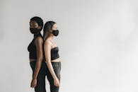 Women Wearing Face Mask Standing Back to Back