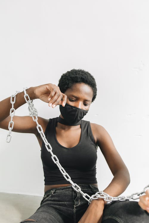 Close-Up Shot of a Woman Bound With Chains · Free Stock Photo