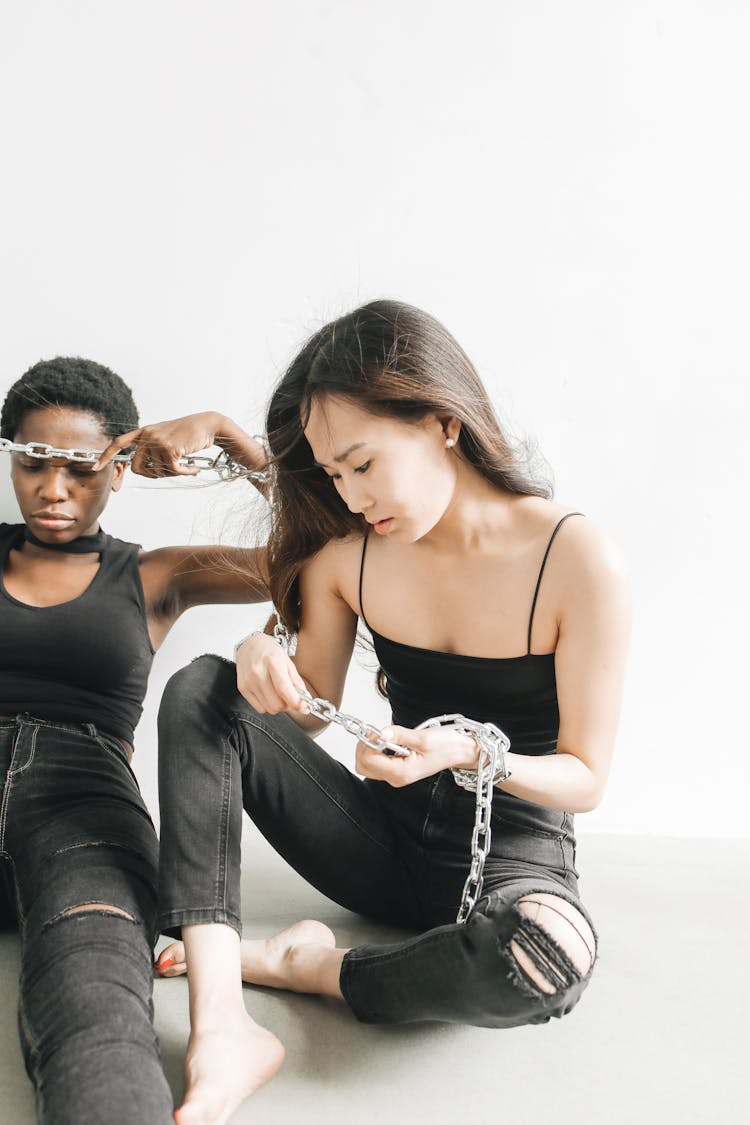 Chained Women Sitting Together