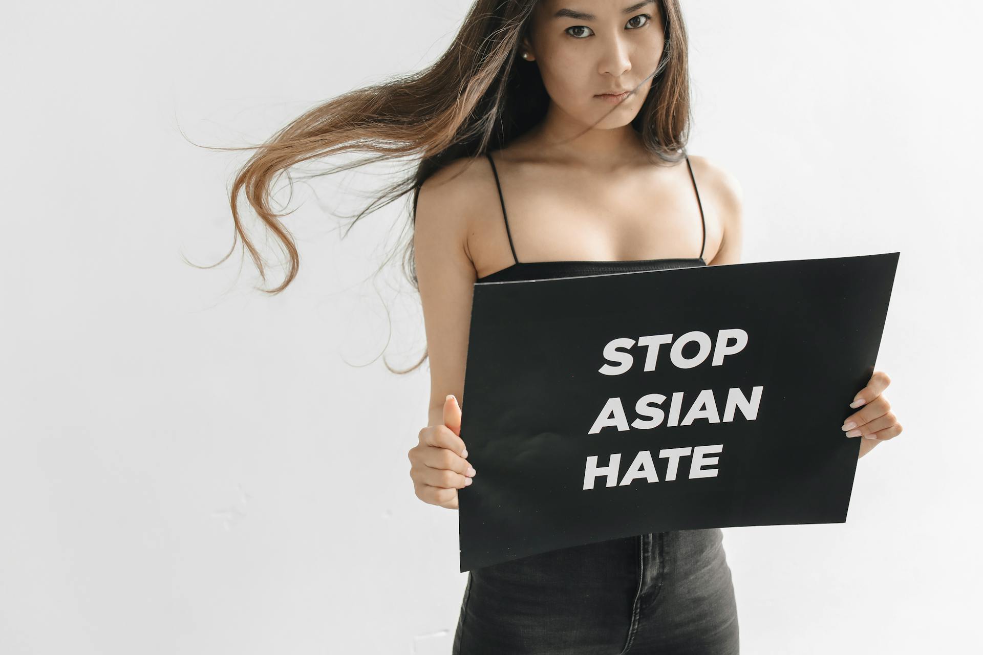 Woman Holding an Anti Racism Protest Sign