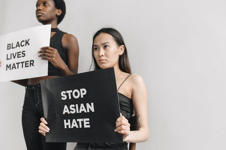 Women Holding Posters On Racism