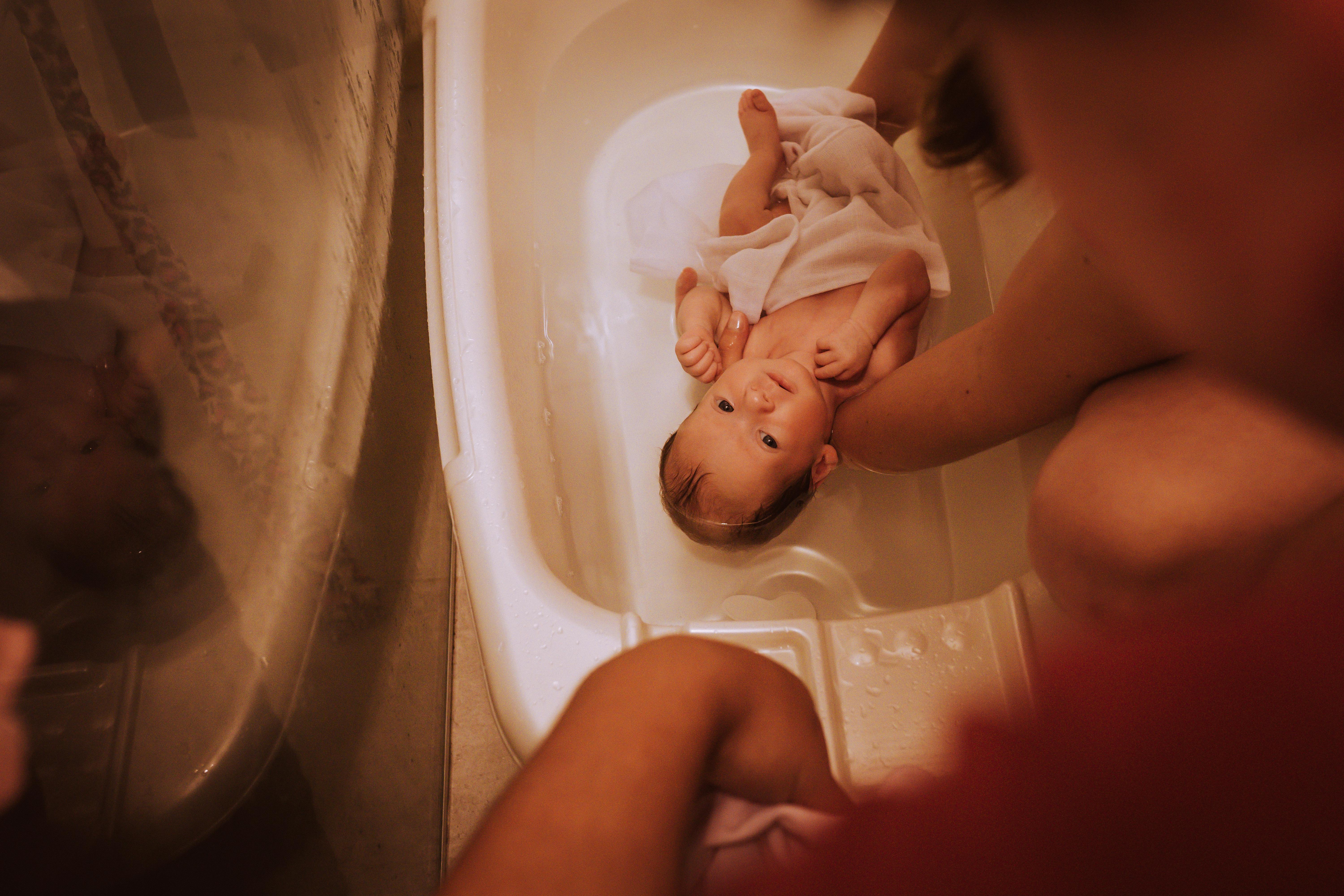 Free High-Angle Shot of a Cute Infant Taking a Bath Stock Photo