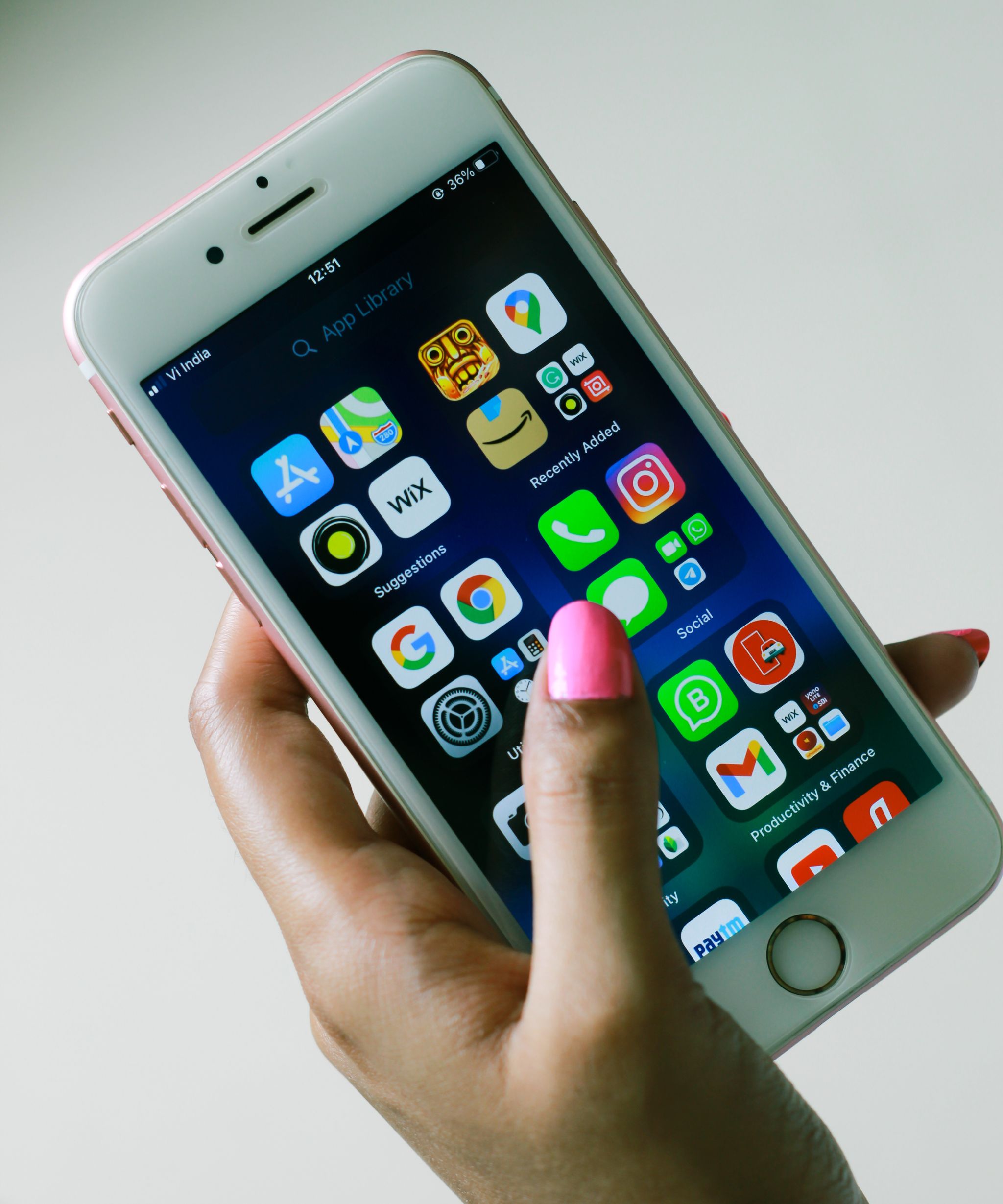 Hand holding a phone showing an app