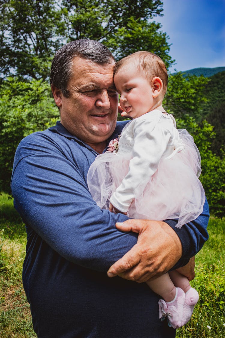 Man Holding A Baby Girl