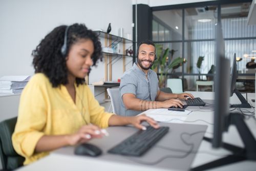 Free A diverse call center team working efficiently with headsets and computers, ensuring quality customer service. Stock Photo