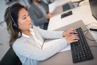 A Woman Typing on the Keyboard
