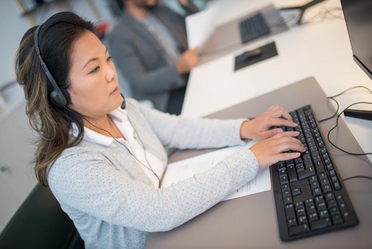 A Woman Typing On The Keyboard