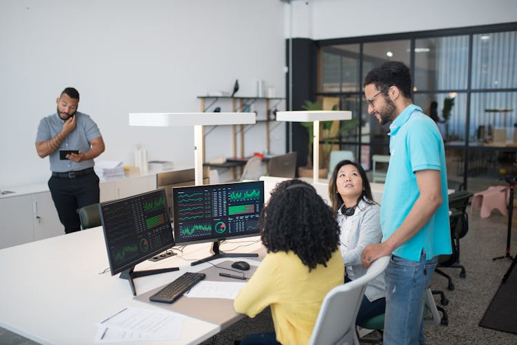 Four People Working In The Office