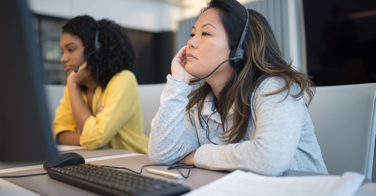 it support technician with headset at desk