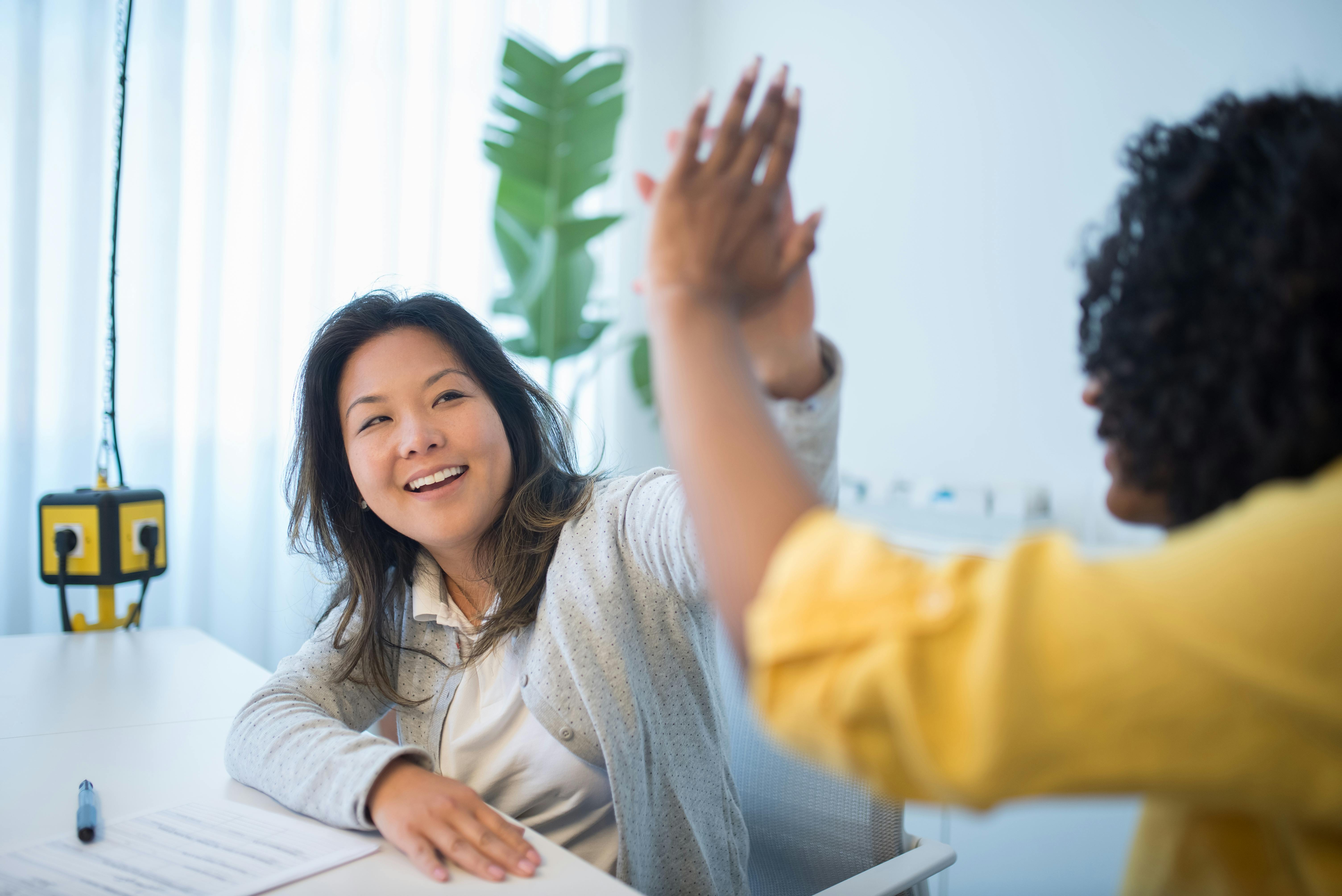 office workers giving high five