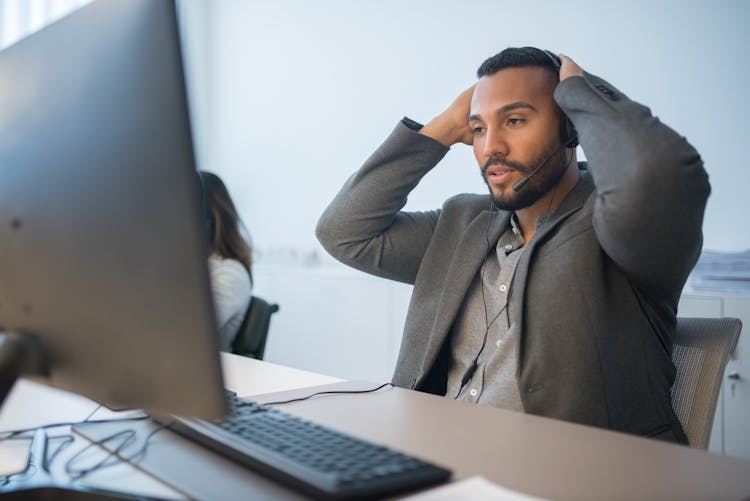 Bearded Man Looking At The Screen Of A Computer