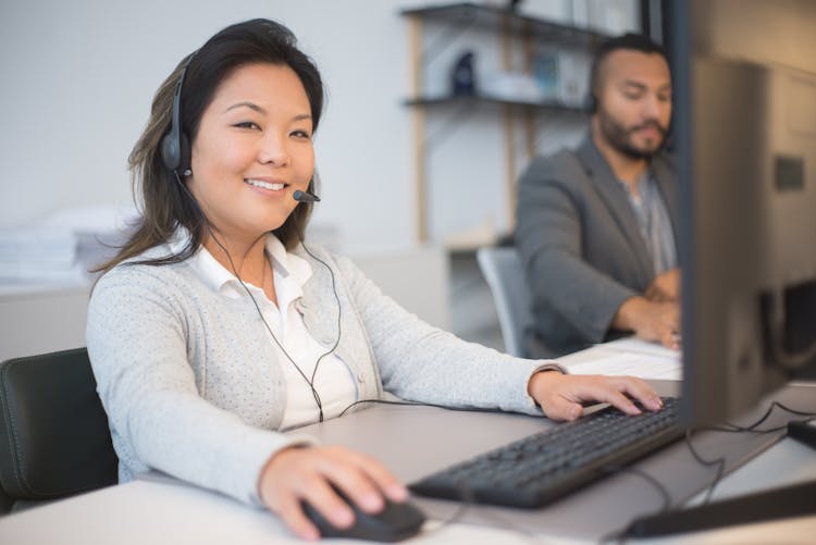 Woman With Headphones On Working On A Computer