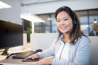 A medical office front desk staffer scheduling a patient appointment by phone
