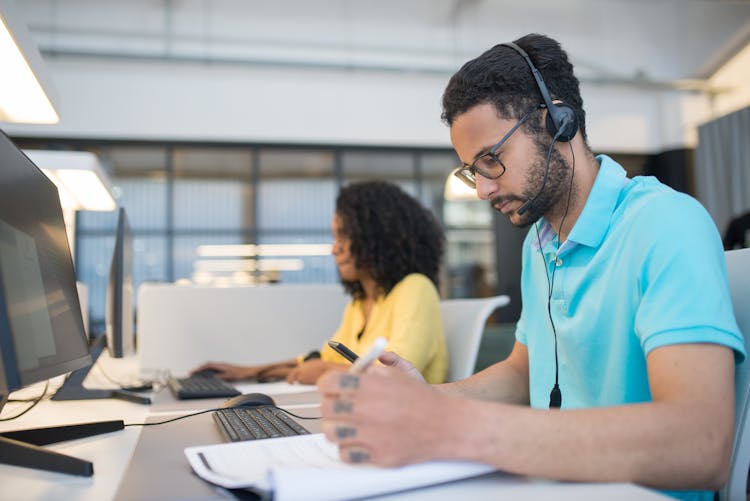 A Man Using Headphones While Working 