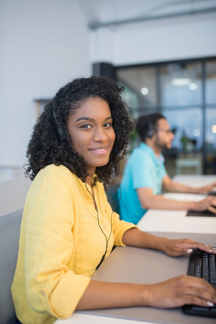 Woman With Headphones On Working On A Computer 