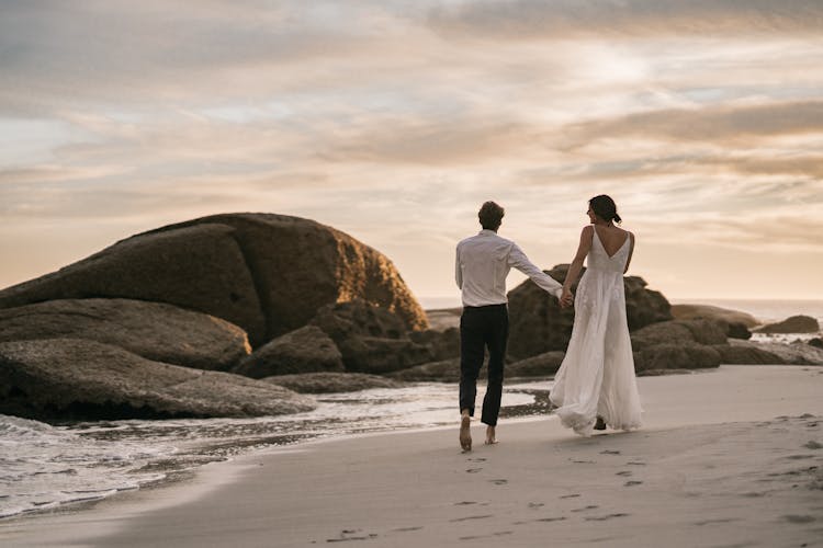 Man And Woman Walking On Beach