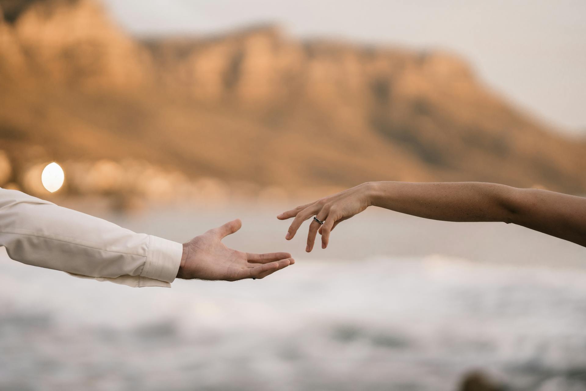 Hands of Man and Woman Reaching Out