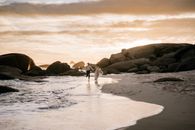 2 People Walking on Beach Shore