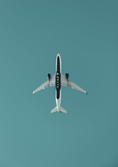 Free White and Blue Airplane in the Sky Stock Photo