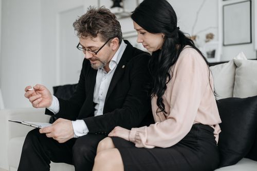 Free Business professionals discussing documents in a modern office setting. Stock Photo