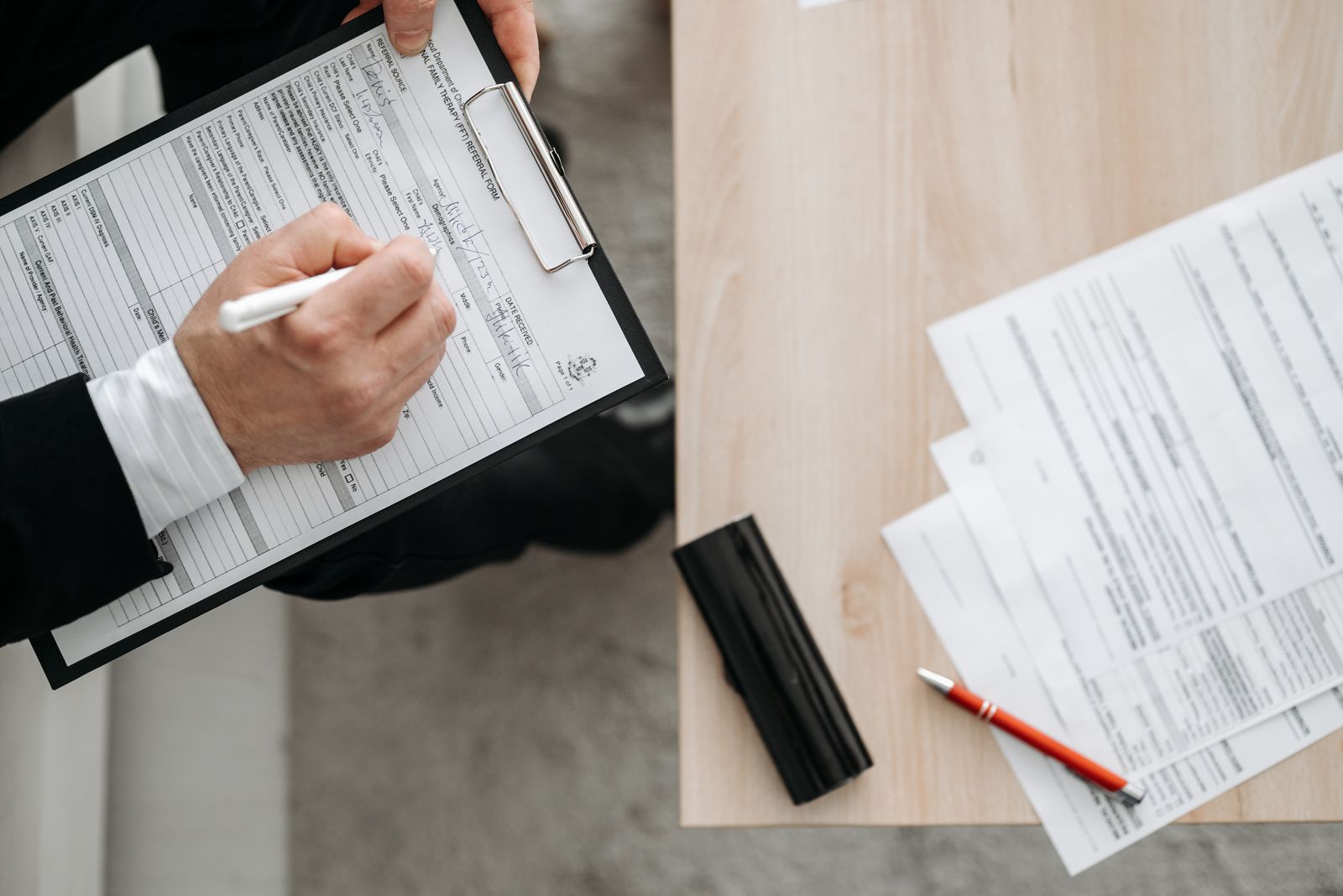 Filling out a medical form on a clipboard