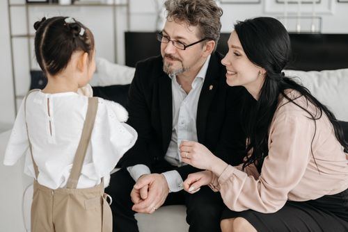Free A joyful moment shared between parents and their child in a cozy indoor setting. Stock Photo