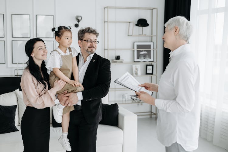 A Social Worker In Front Of A Child With Foster Parents