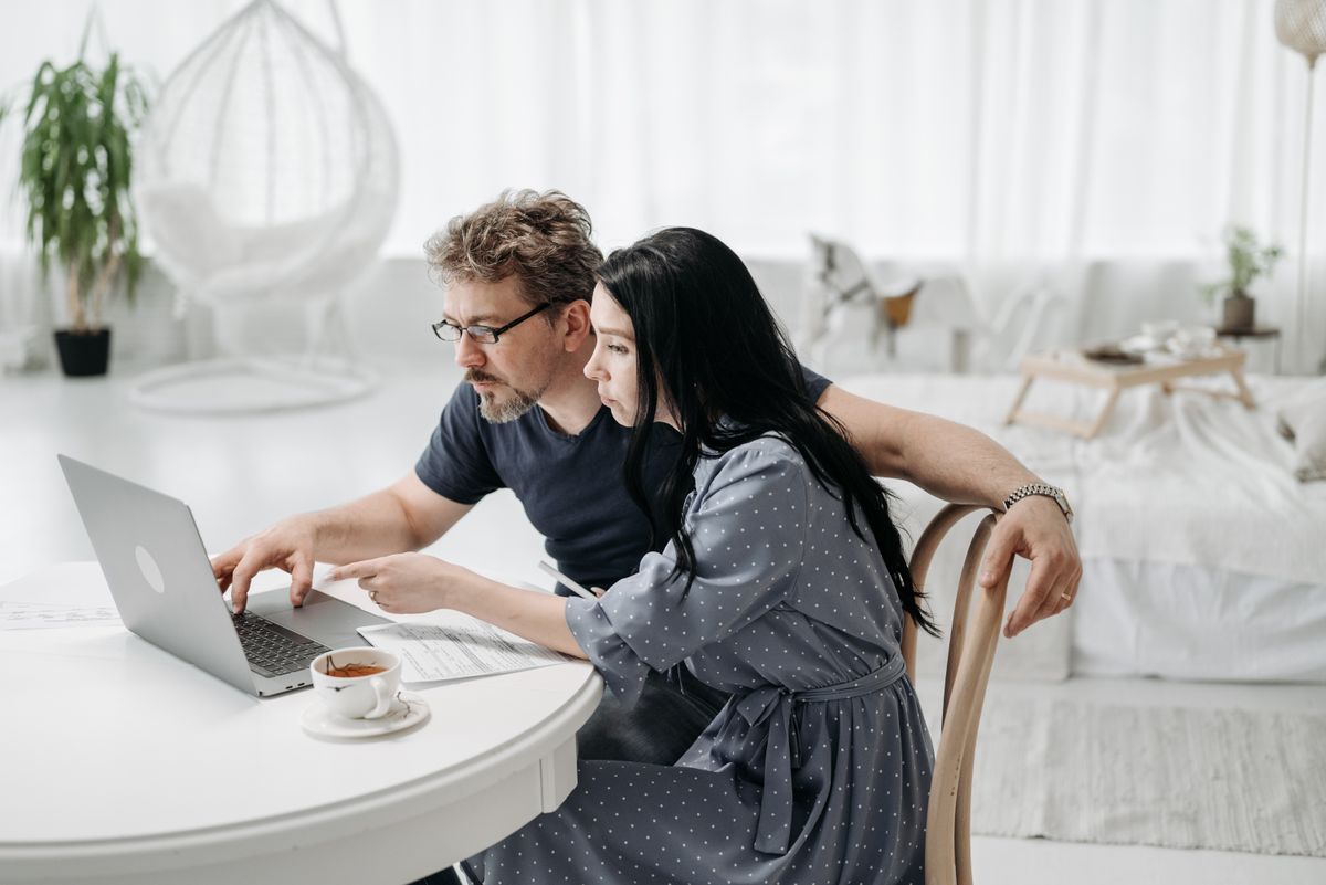 Couple at home reviewing a written hospital estimate together on a laptop