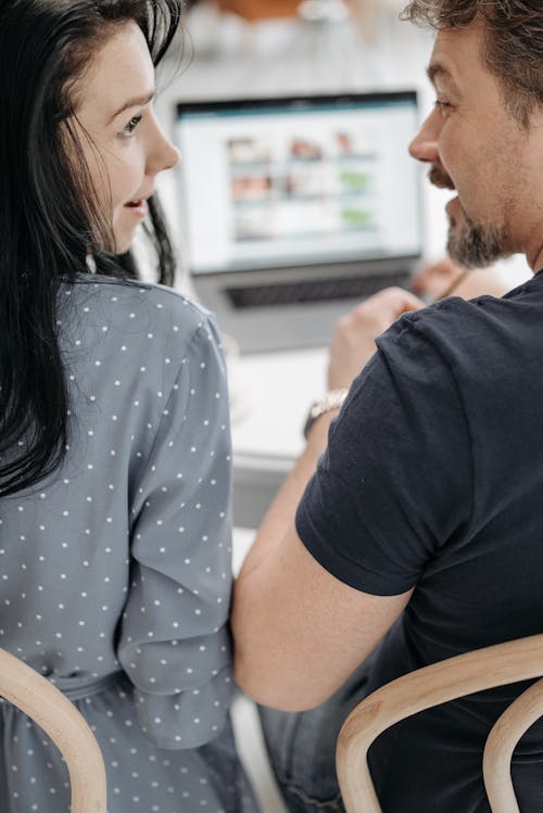 Free A Couple Looking at Each Other while Talking Stock Photo
