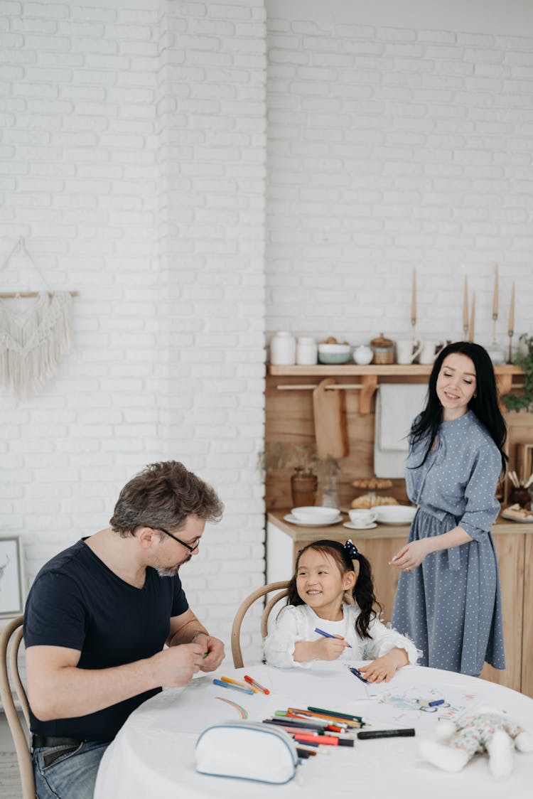 A Man And A Young Girl Sitting On A Chair