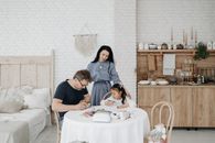 Man and Woman Sitting on Chair in Front of Table