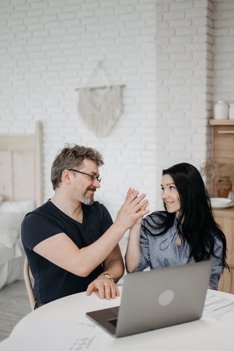 A Man And A Woman Sitting At Table