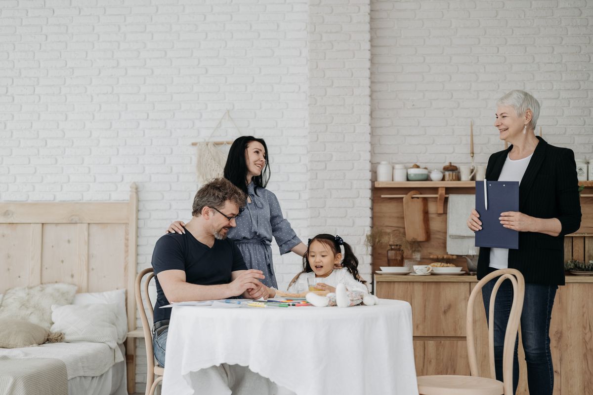 A family sitting together at a table, symbolizing protection and care