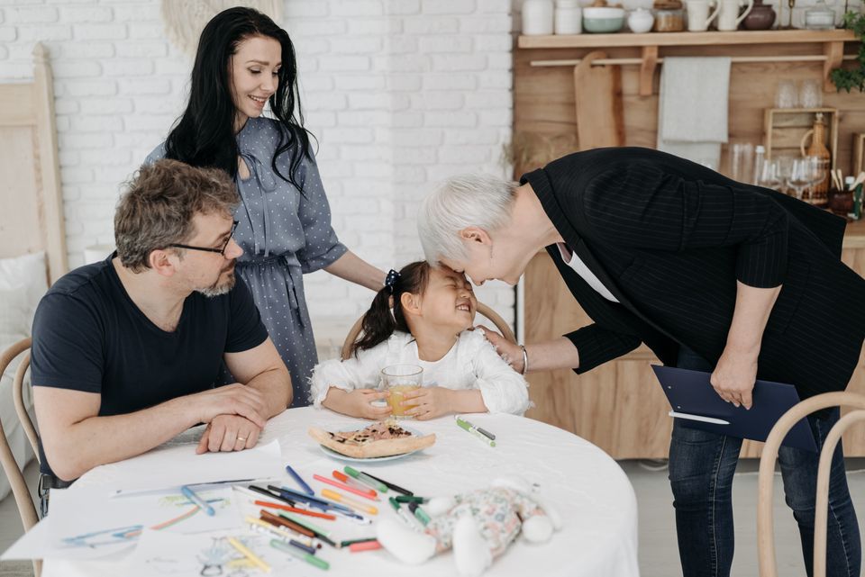 A family meets with a social worker in a welcoming home setting.