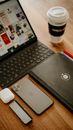 Working desk with collection of devices and cup of coffee