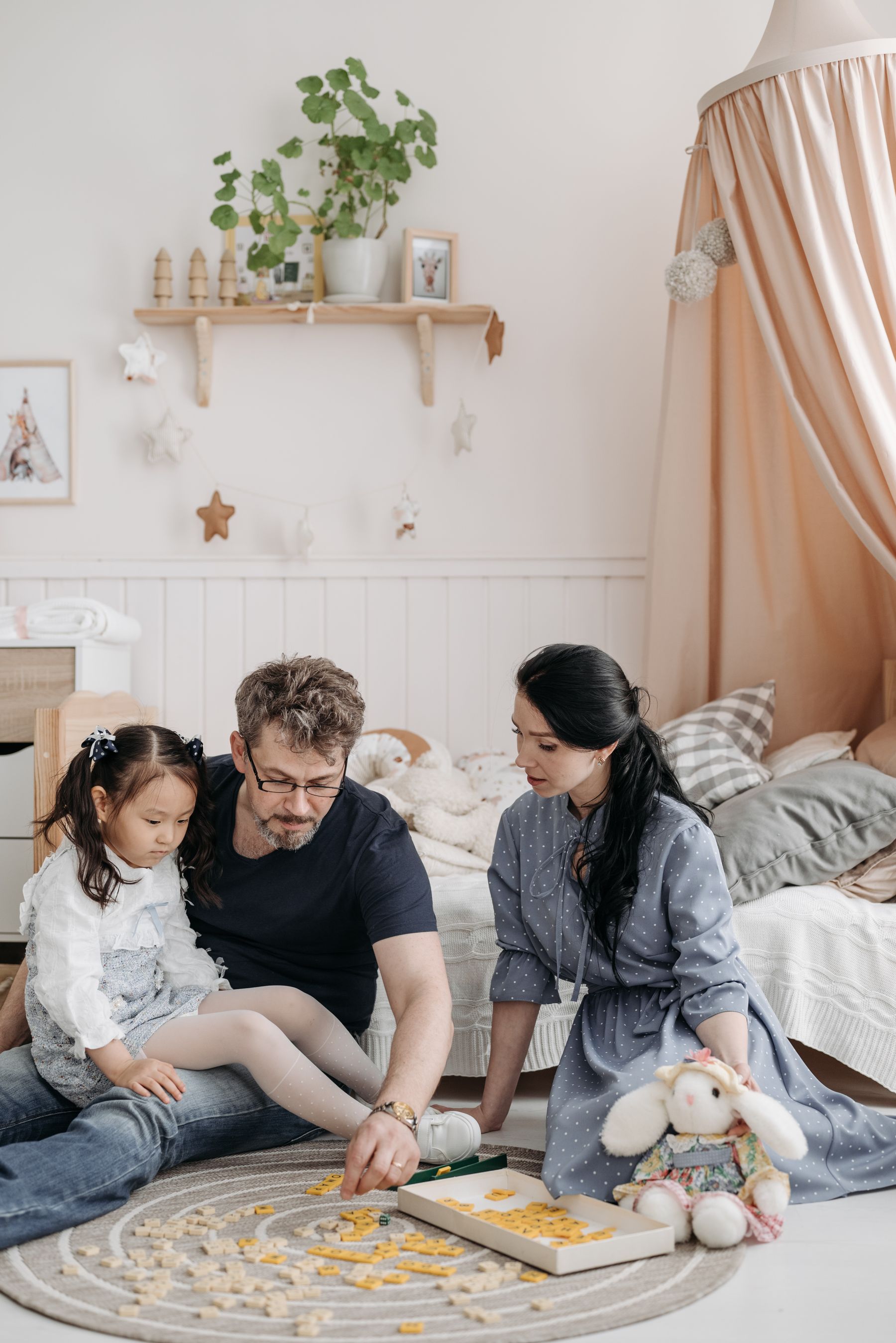 Family enjoying a board game together in a comfortable bright living room
