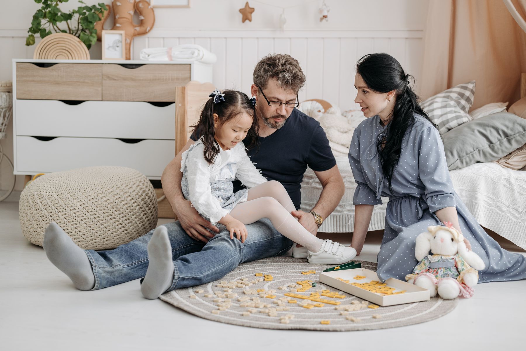 A family enjoying a board game together in a bright home