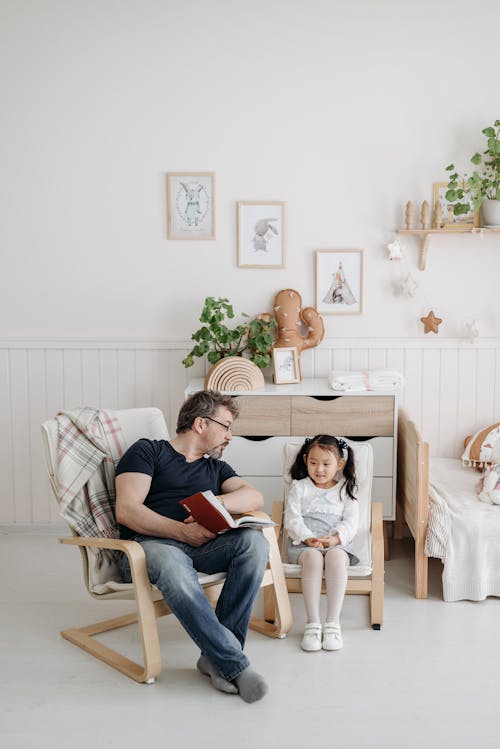 Free Father Reading a Book to His Daughter Stock Photo