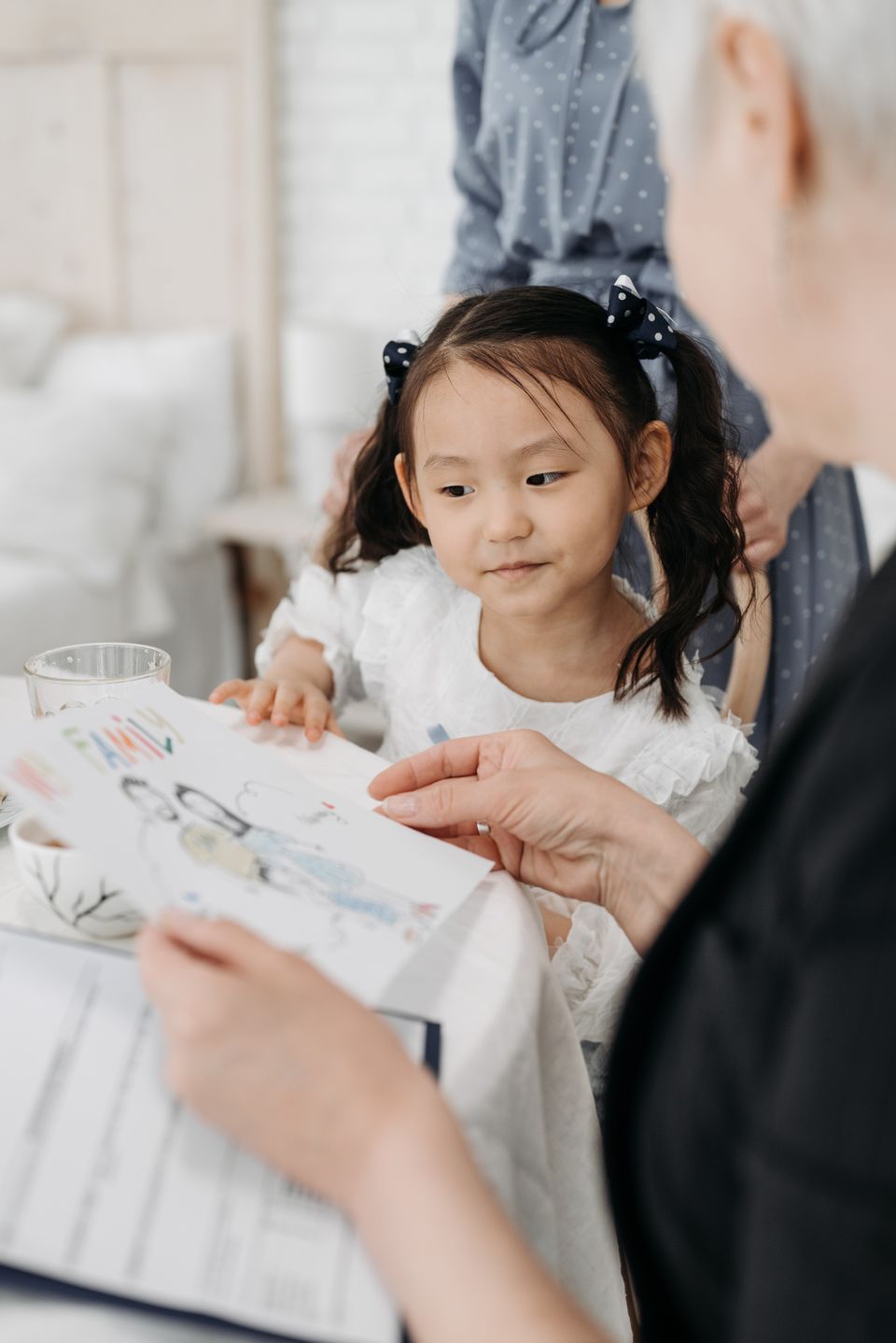 A child and social worker spend time together in a supportive setting.
