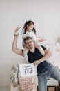 Father and Daughter Smiling at the Camera