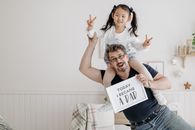 Father and Daughter Smiling at the Camera