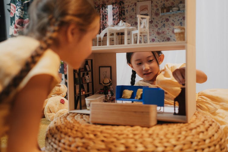 Girls Playing A Dollhouse