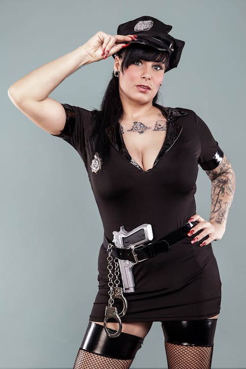 Free A Sexy Policewoman with a Gun on Her Waist Stock Photo