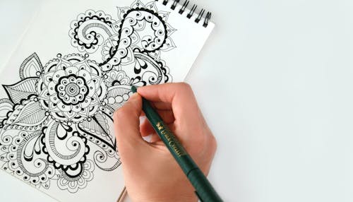 Free Person Holding Black Pen Sketching Flower Stock Photo