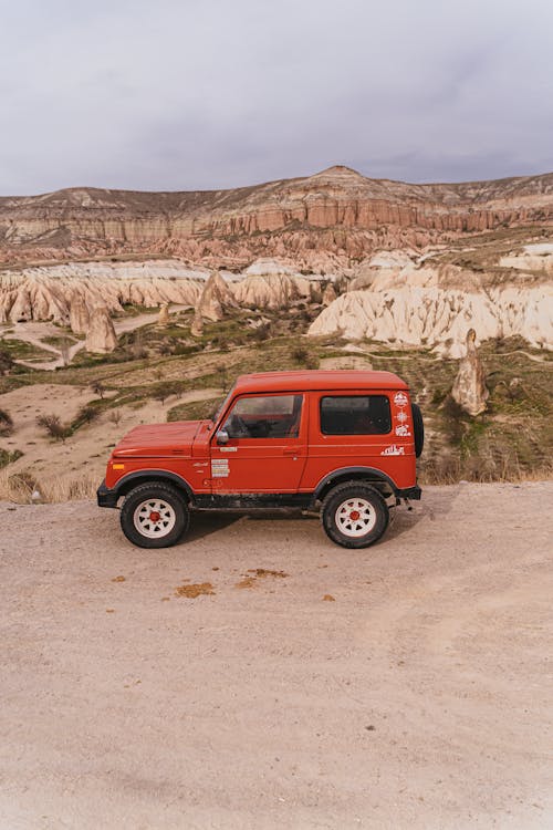 Red Suv on Brown Sand