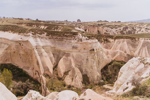 Free A scenic view of Cappadocia's distinctive rock formations under a cloudy sky, perfect for travel enthusiasts. Stock Photo